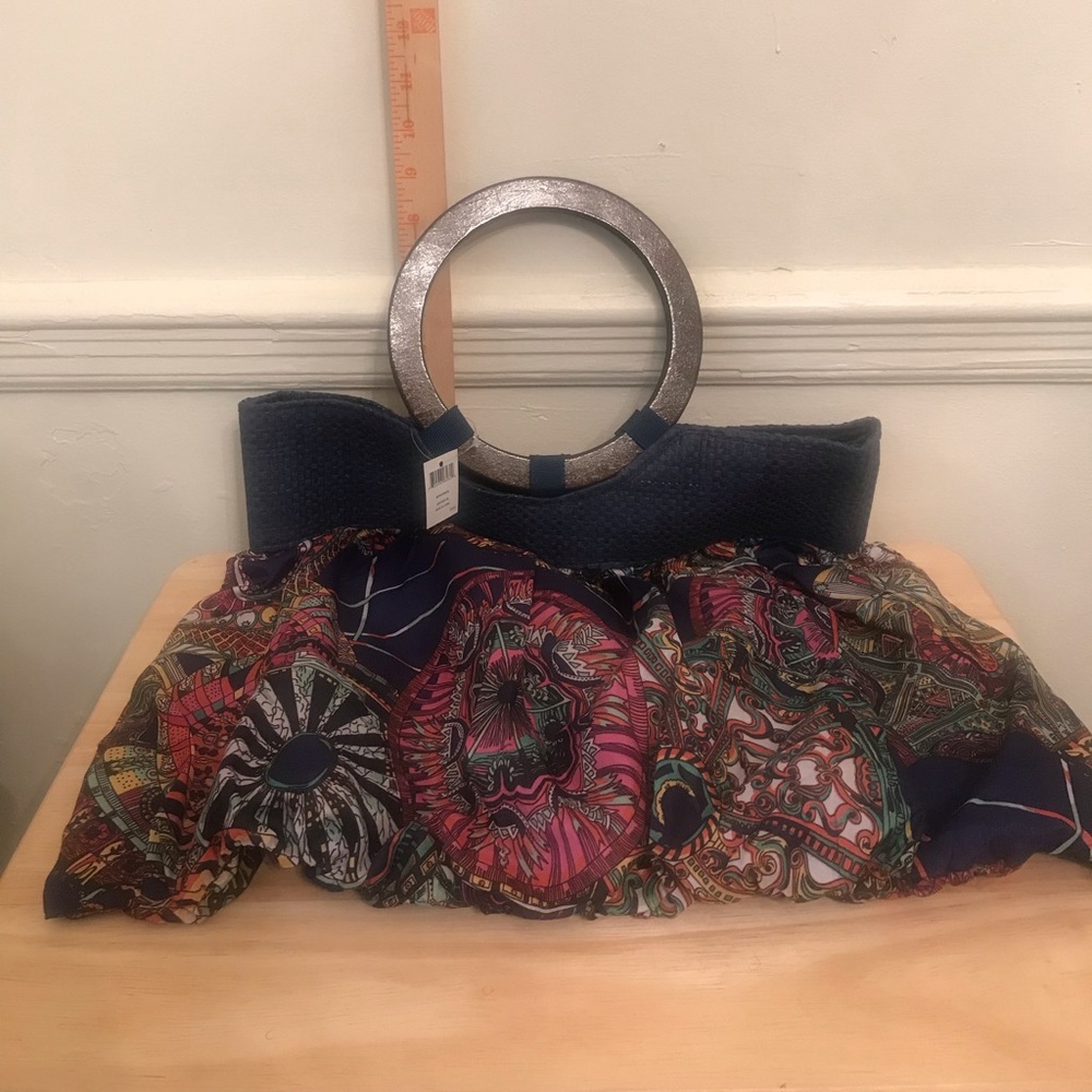 Cloth purse with wood handles.